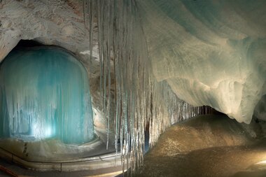 Ice cave with shimmering icicles and frozen waterfall, showcasing impressive glacier formations in Salzburger Land. | © Eisriesenwelt Werfen