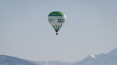 Hot air balloon flying over the mountains in Zell am See-Kaprun.