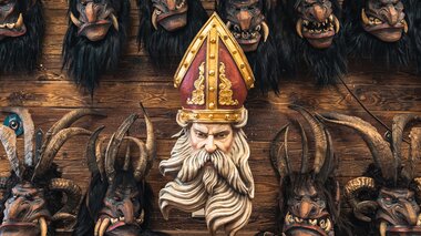 Various demon masks and a large bearded mask, traditionally used in Nikolaus or Krampus celebrations.