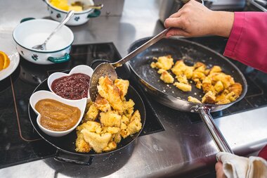 Cooking Kaiserschmarrn in a pan, served with jams in small bowls. | © Zell am See-Kaprun Tourismus