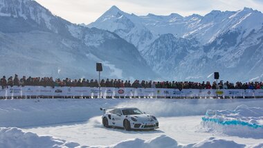 A speedy sports car at the GP Ice Race on icy ground with a stunning mountain backdrop. | © Nikolaus Faistauer Photography