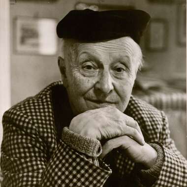 Black and white portrait of an elderly person wearing a beret, with hands clasped in front of their face. | © Eberhard Spangenberg/ Bildrecht, Wien, 2018