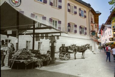 Historical photo of the marketplace in Zell am See with horse-drawn carriage and market stalls