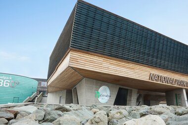 Modern visitor center of the High Tauern National Park with wood and glass architecture. | © Harry Liebmann