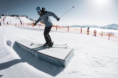 Skier rider using a rail in the snowpark on the ski slope for tricks. | © Schmittenhöhe