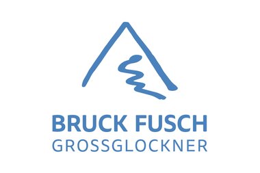 Logo of the sponsor Bruck Fusch Grossglockner, featuring a mountain symbol and blue text. | © Bruck Fusch