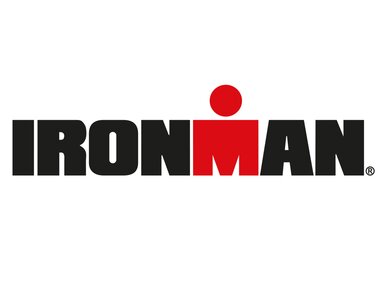 IRONMAN logo with black letters and a red dot replacing the 'I' in the center. | © IRONMAN